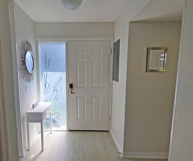 1311 Siesta Bayside Dr Unit 1311-A, Sarasota, FL 34242 - foyer featuring light wood-style floors, electric panel, and baseboards