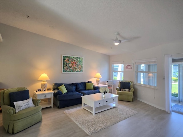 1311 Siesta Bayside Dr Unit 1311-A, Sarasota, FL 34242 - living room with light wood-style floors, plenty of natural light, ceiling fan, and a textured ceiling