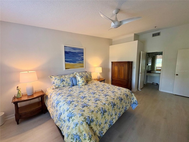 1311 Siesta Bayside Dr Unit 1311-A, Sarasota, FL 34242 - bedroom with wood finished floors, a textured ceiling, baseboards, and ceiling fan