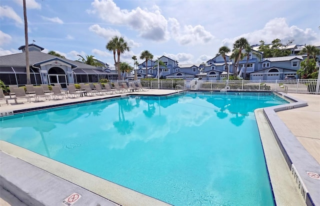1311 Siesta Bayside Dr Unit 1311-A, Sarasota, FL 34242 - community pool with a residential view, fence, and a patio