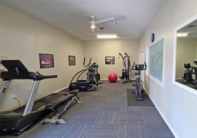 1311 Siesta Bayside Dr Unit 1311-A, Sarasota, FL 34242 - workout room with ceiling fan, carpet floors, and baseboards