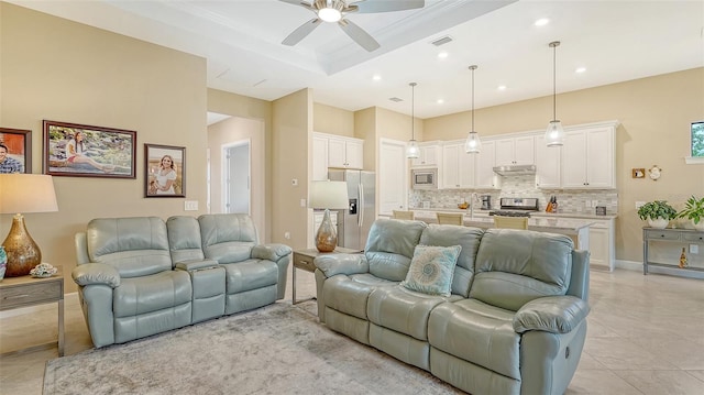 living area with a ceiling fan, light tile patterned floors, a raised ceiling, and recessed lighting