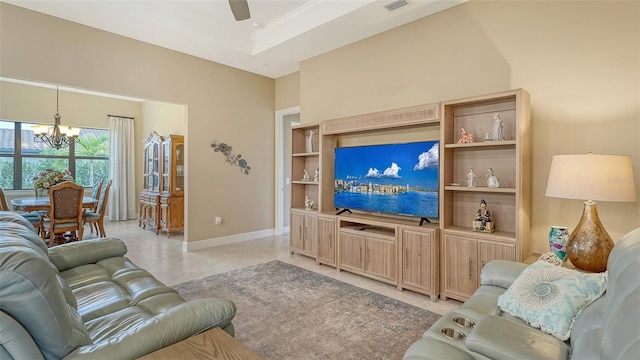 living room featuring a chandelier, baseboards, ceiling fan, light tile patterned floors, and crown molding