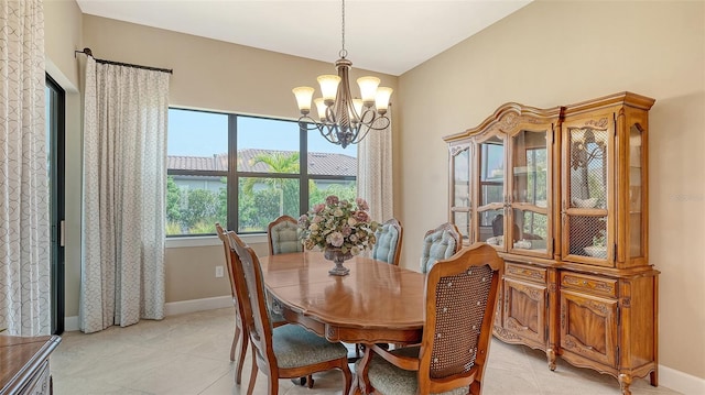 dining space featuring a chandelier, baseboards, and light tile patterned flooring