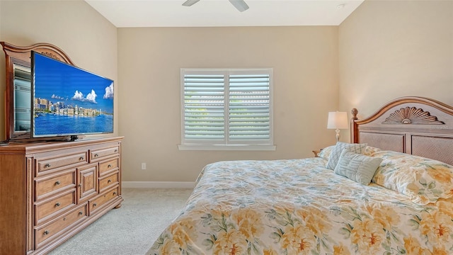 bedroom with light carpet, baseboards, and a ceiling fan