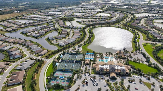 aerial overview of property's location featuring a nearby body of water and nearby suburban area