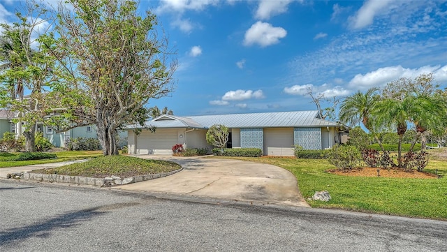 4361 Pompano Ln, Palmetto, FL 34221 - single story home with a front lawn, driveway, an attached garage, and metal roof