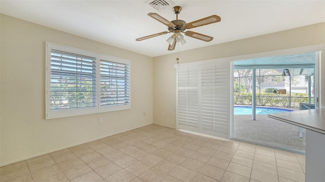 4361 Pompano Ln, Palmetto, FL 34221 - spare room featuring healthy amount of natural light, ceiling fan, light tile patterned floors, and baseboards