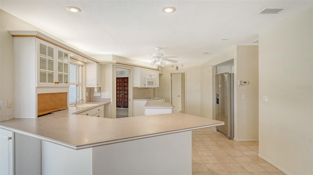 4361 Pompano Ln, Palmetto, FL 34221 - kitchen with a sink, white microwave, high end fridge, a peninsula, and ceiling fan