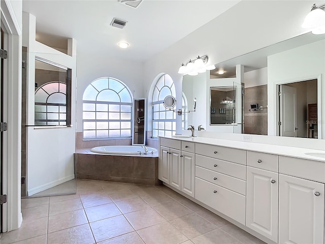 4239 Corso Venetia Blvd, Venice, FL 34293 - bathroom featuring double vanity, a garden tub, tile patterned flooring, baseboards, and tiled shower