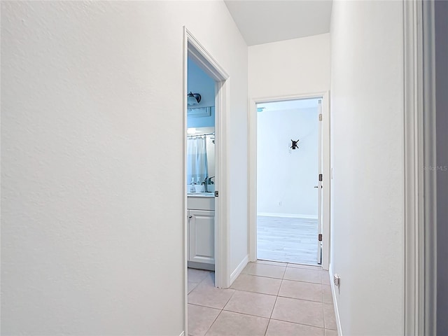 4239 Corso Venetia Blvd, Venice, FL 34293 - corridor featuring light tile patterned floors and baseboards