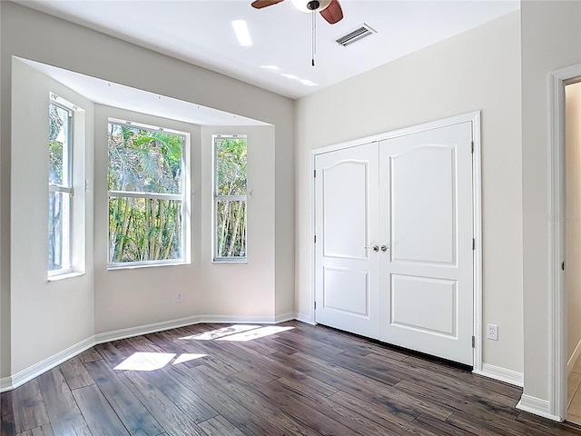 4239 Corso Venetia Blvd, Venice, FL 34293 - unfurnished bedroom featuring dark wood-style flooring, baseboards, and a closet