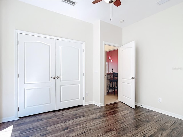 4239 Corso Venetia Blvd, Venice, FL 34293 - unfurnished bedroom featuring dark wood-style floors, a closet, baseboards, and ceiling fan
