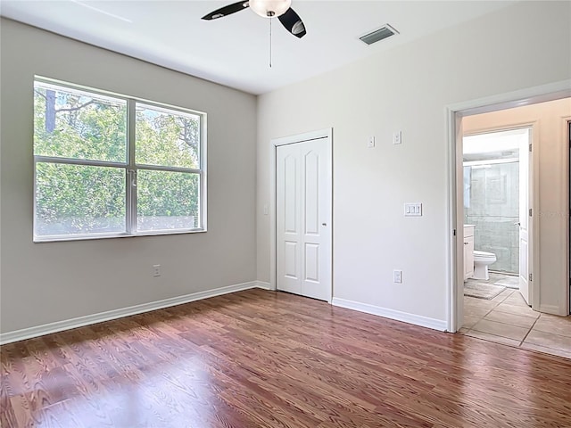 4239 Corso Venetia Blvd, Venice, FL 34293 - unfurnished bedroom with wood finished floors, baseboards, ceiling fan, and a closet
