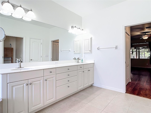 4239 Corso Venetia Blvd, Venice, FL 34293 - bathroom with double vanity, tile patterned floors, baseboards, and a ceiling fan