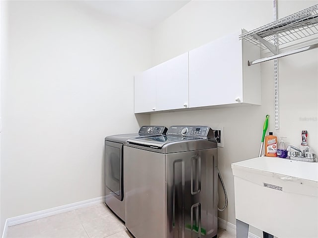 4239 Corso Venetia Blvd, Venice, FL 34293 - washroom with independent washer and dryer, baseboards, cabinet space, and light tile patterned flooring