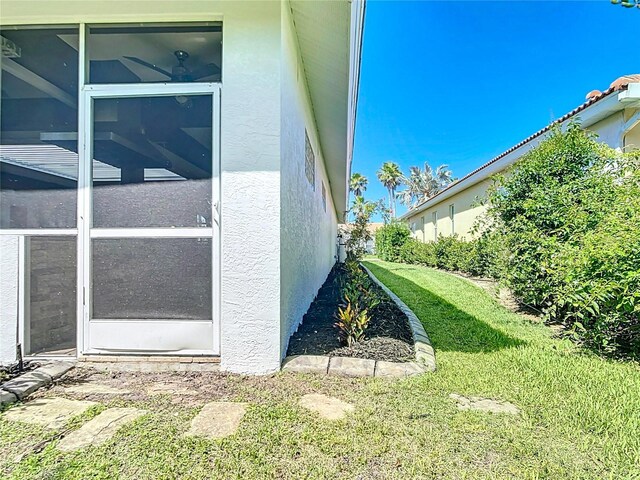 4239 Corso Venetia Blvd, Venice, FL 34293 - view of side of home with stucco siding and a yard
