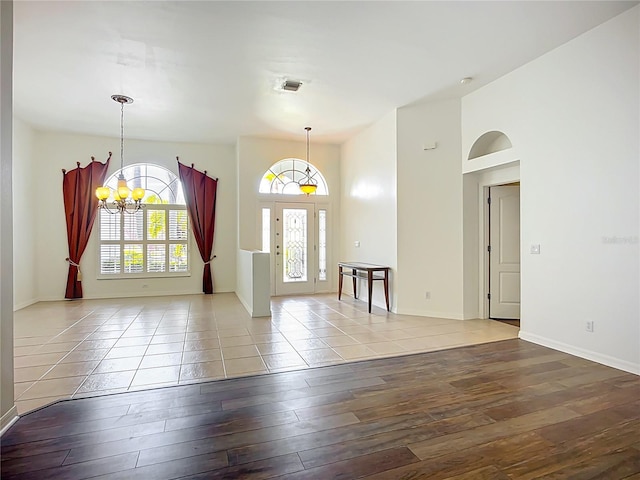 4239 Corso Venetia Blvd, Venice, FL 34293 - foyer featuring wood-type flooring, a chandelier, and baseboards