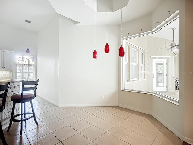 4239 Corso Venetia Blvd, Venice, FL 34293 - unfurnished dining area with light tile patterned floors, baseboards, and ceiling fan