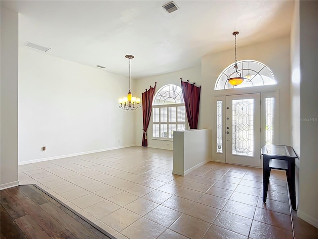 4239 Corso Venetia Blvd, Venice, FL 34293 - tiled entryway with a chandelier and baseboards