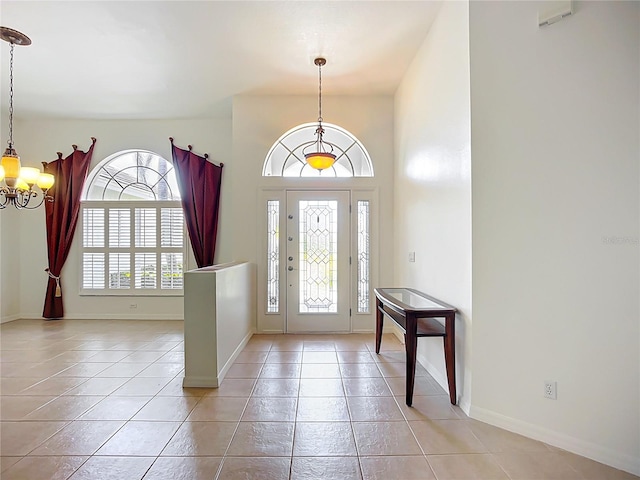 4239 Corso Venetia Blvd, Venice, FL 34293 - foyer entrance featuring a chandelier, light tile patterned floors, and baseboards