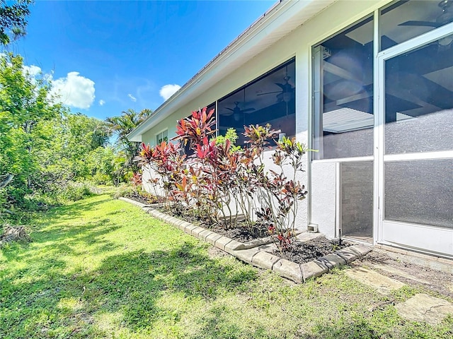 4239 Corso Venetia Blvd, Venice, FL 34293 - view of property exterior with a yard and a ceiling fan