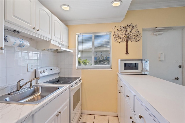 475 Benjamin Franklin Dr Unit 211, Sarasota, FL 34236 - kitchen with white appliances, a sink, under cabinet range hood, crown molding, and white cabinets