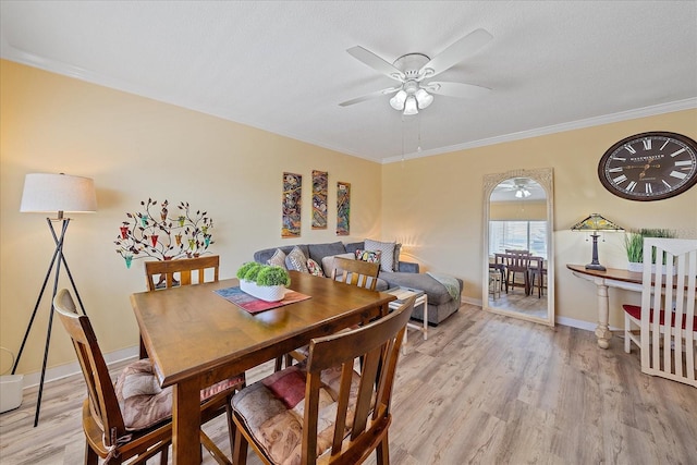 475 Benjamin Franklin Dr Unit 211, Sarasota, FL 34236 - dining space featuring a ceiling fan, light wood finished floors, ornamental molding, and baseboards
