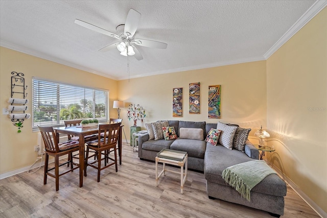 475 Benjamin Franklin Dr Unit 211, Sarasota, FL 34236 - living room featuring a textured ceiling, light wood finished floors, crown molding, ceiling fan, and baseboards