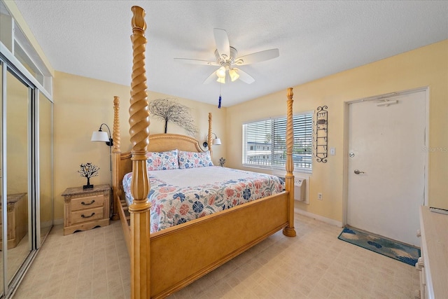 475 Benjamin Franklin Dr Unit 211, Sarasota, FL 34236 - bedroom featuring a closet, baseboards, a textured ceiling, and a ceiling fan