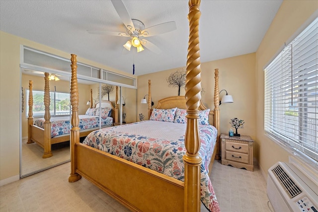 475 Benjamin Franklin Dr Unit 211, Sarasota, FL 34236 - bedroom featuring a wall mounted air conditioner, baseboards, and ceiling fan