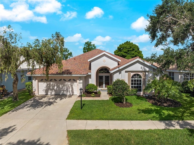 6248 Donnington Ct, Sarasota, FL 34238 - view of front of property with an attached garage, stucco siding, a front lawn, a tiled roof, and concrete driveway