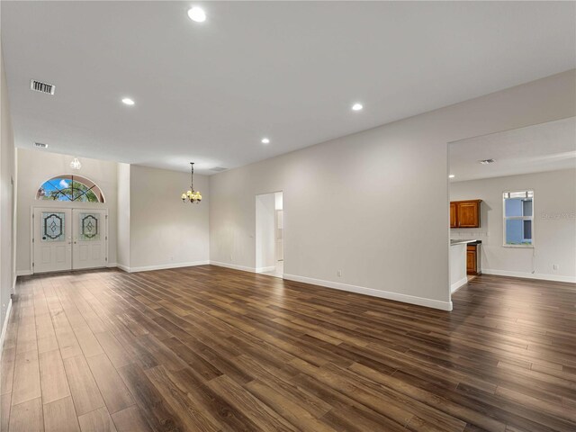 6248 Donnington Ct, Sarasota, FL 34238 - unfurnished living room with a chandelier, dark wood-style flooring, recessed lighting, baseboards, and plenty of natural light