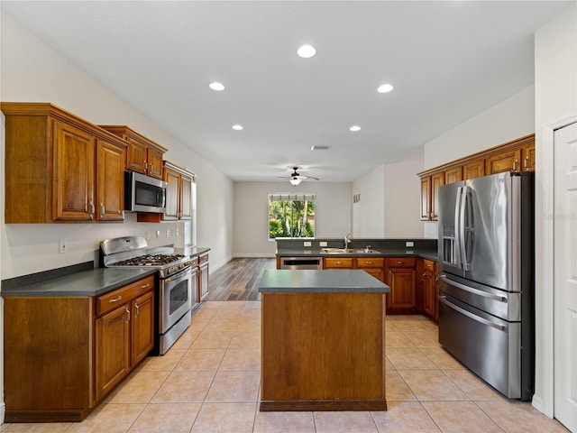 6248 Donnington Ct, Sarasota, FL 34238 - kitchen featuring appliances with stainless steel finishes, a peninsula, dark countertops, a sink, and ceiling fan