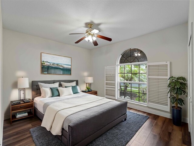 6248 Donnington Ct, Sarasota, FL 34238 - bedroom featuring dark wood-style flooring, ceiling fan, and baseboards