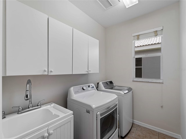 6248 Donnington Ct, Sarasota, FL 34238 - clothes washing area featuring separate washer and dryer, cabinet space, baseboards, and light tile patterned floors