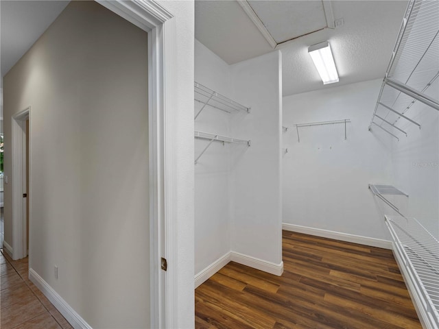 6248 Donnington Ct, Sarasota, FL 34238 - walk in closet with dark wood-style floors