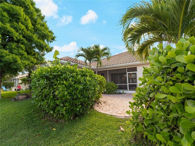 6248 Donnington Ct, Sarasota, FL 34238 - view of green lawn featuring a sunroom and a patio area