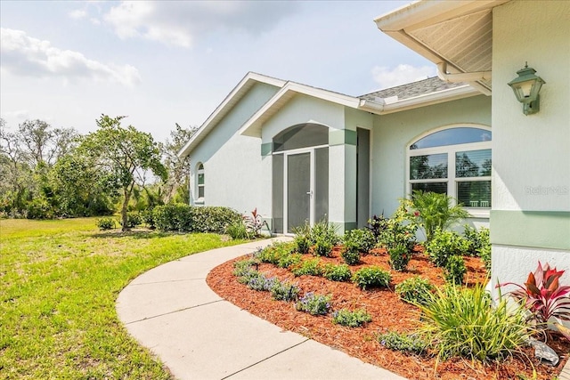 10001 289th St E, Myakka City, FL 34251 - view of exterior entry with a lawn and stucco siding