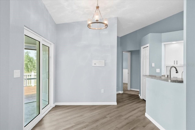 10001 289th St E, Myakka City, FL 34251 - unfurnished dining area with light wood-style flooring and a chandelier