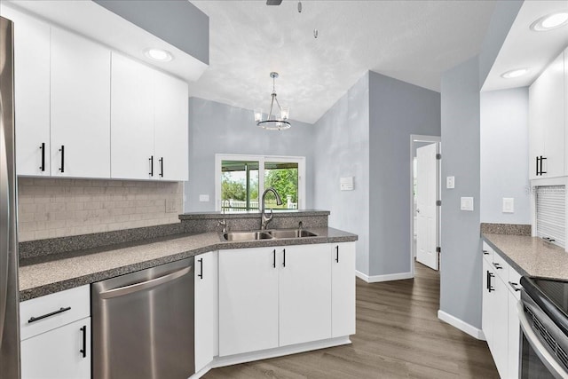 10001 289th St E, Myakka City, FL 34251 - kitchen with appliances with stainless steel finishes, backsplash, a peninsula, wood finished floors, and white cabinets