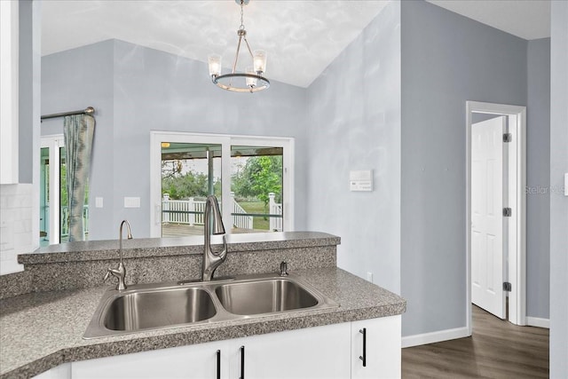 10001 289th St E, Myakka City, FL 34251 - kitchen with dark wood-style floors, white cabinets, pendant lighting, vaulted ceiling, and a chandelier