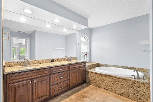 10001 289th St E, Myakka City, FL 34251 - full bathroom with a garden tub, double vanity, tile patterned floors, and recessed lighting