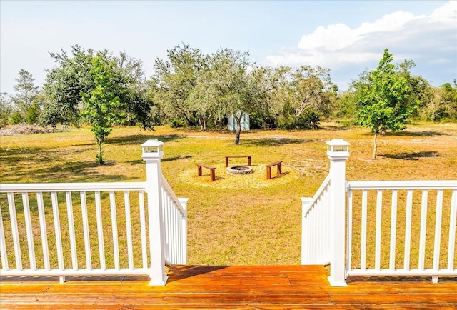 10001 289th St E, Myakka City, FL 34251 - view of green lawn with a deck and a fire pit