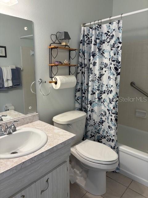2218 Orange Blossom Ln Unit 0, Bradenton, FL 34207 - full bath with tile patterned floors, toilet, shower / tub combo, and vanity