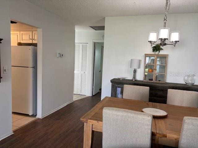 2218 Orange Blossom Ln Unit 0, Bradenton, FL 34207 - dining space with a chandelier, wood finished floors, and baseboards