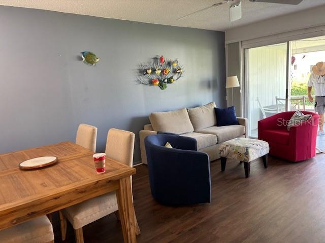 2218 Orange Blossom Ln Unit 0, Bradenton, FL 34207 - living area featuring a ceiling fan, wood finished floors, and a textured ceiling