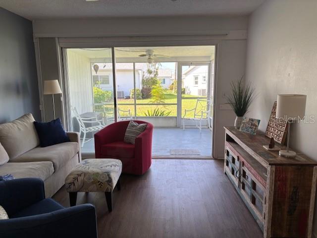 2218 Orange Blossom Ln Unit 0, Bradenton, FL 34207 - living area featuring wood finished floors and ceiling fan