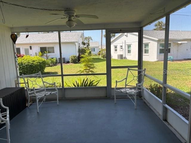 2218 Orange Blossom Ln Unit 0, Bradenton, FL 34207 - unfurnished sunroom featuring a ceiling fan and a residential view