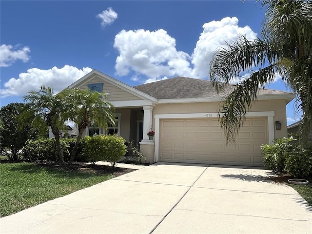 view of front of house featuring a garage, stucco siding, and concrete driveway